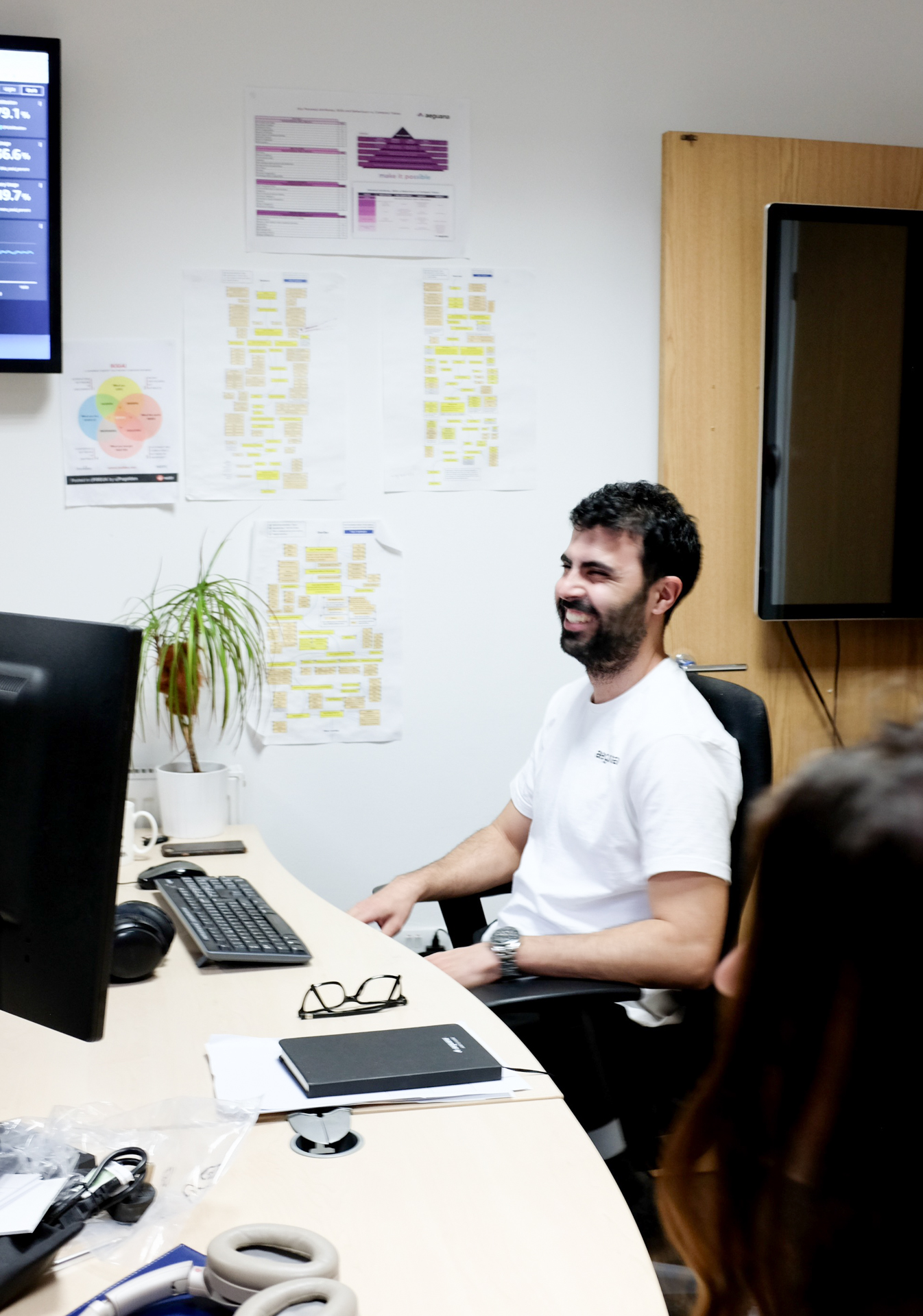 Smiling man sat at desk