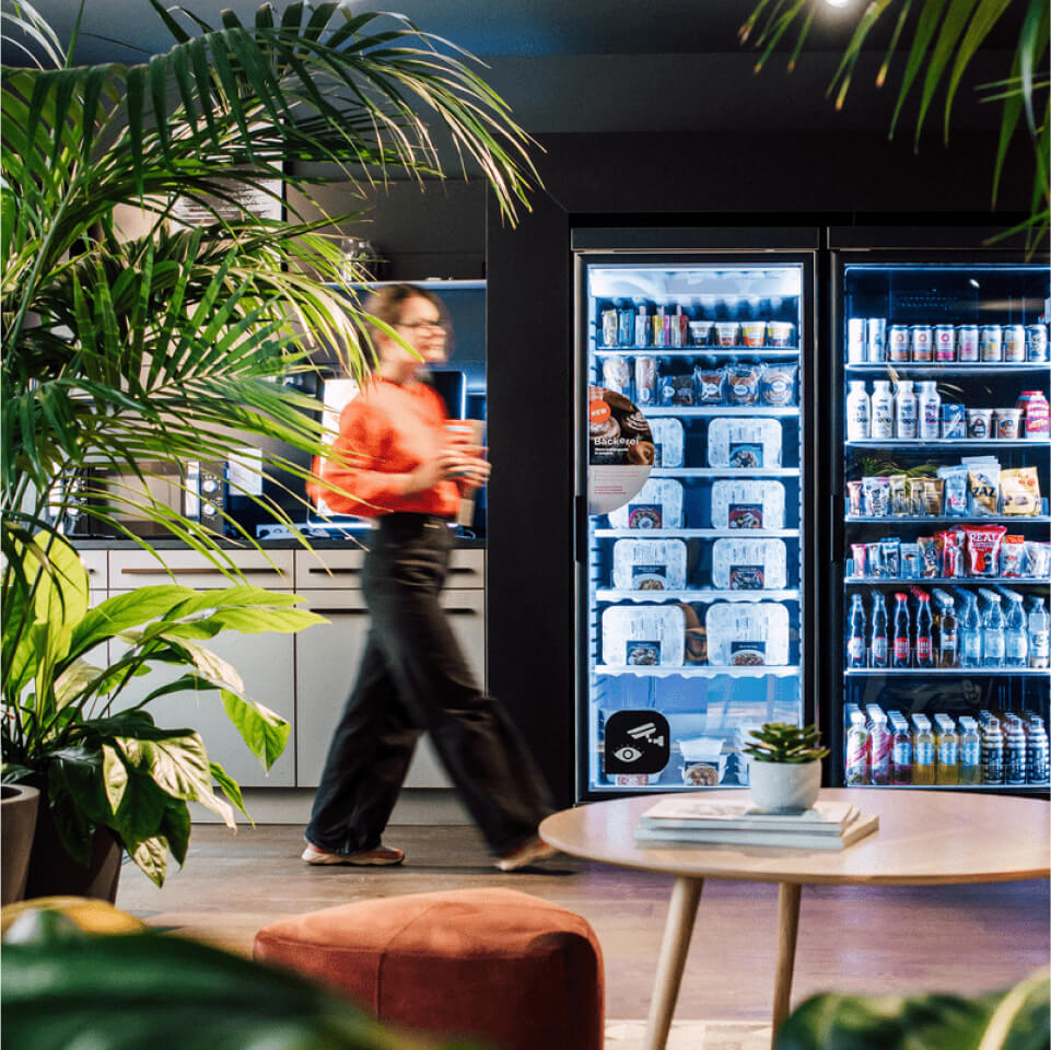 Woman walking past Boost machines